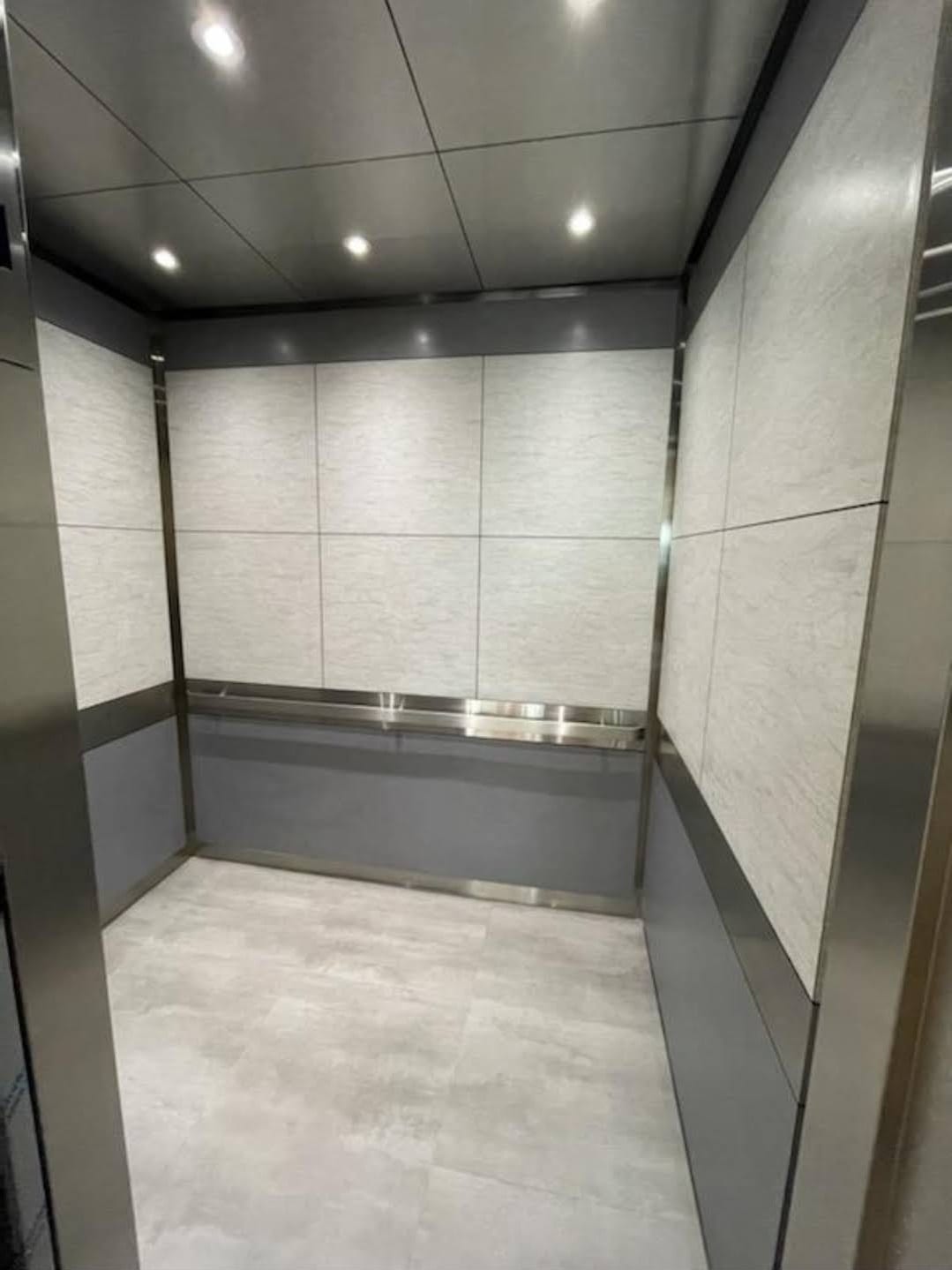 Luxury elevator cab interior showcasing premium materials and LED lighting